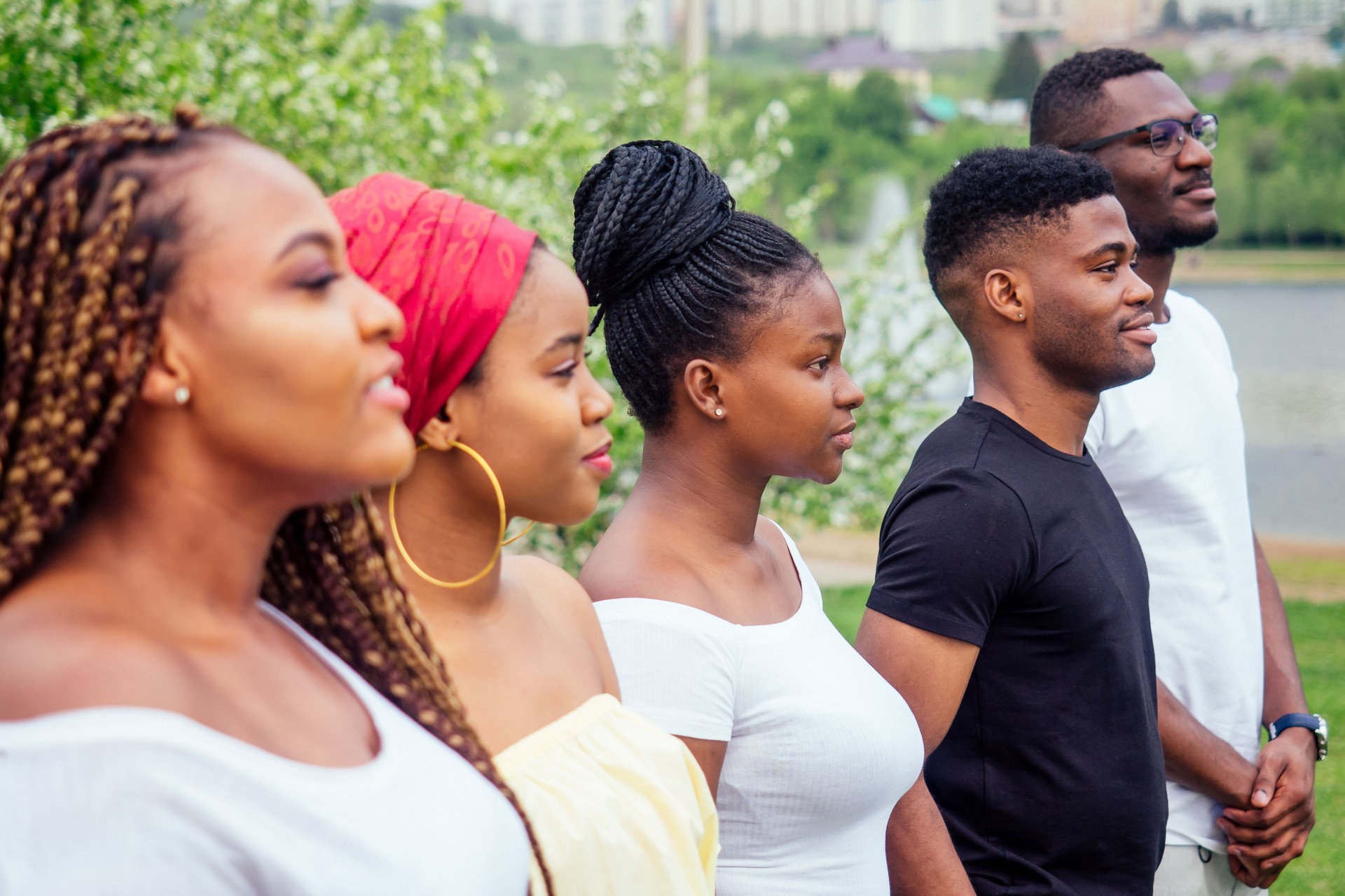 group of five smiling african-american men and women walking outside cloudy weather near the lake,exchange students in Russia